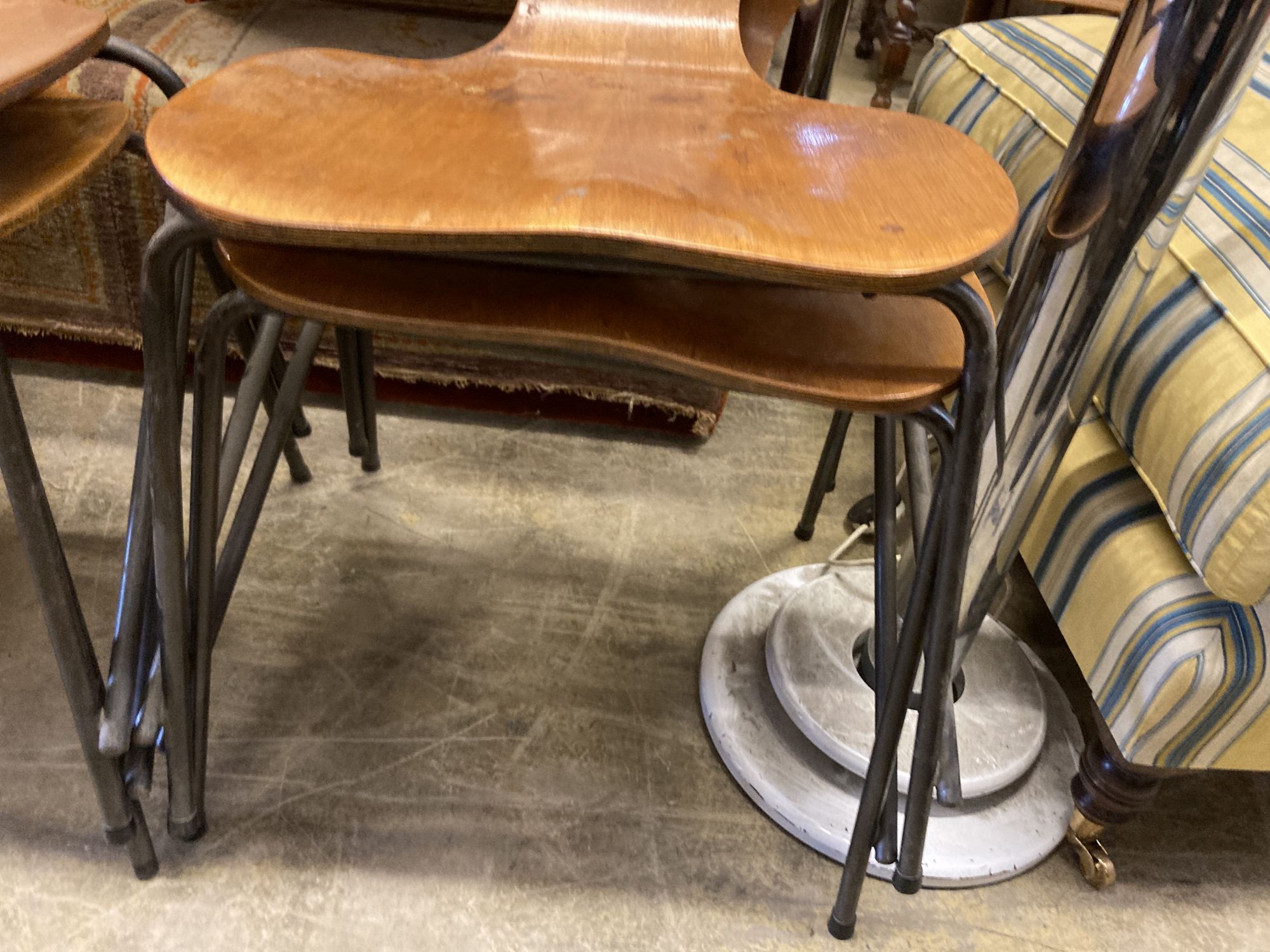 A set of four Jacobsen style bent-ply and tubular metal stacking dining chairs, width 44cm, depth 42cm, height 86cm